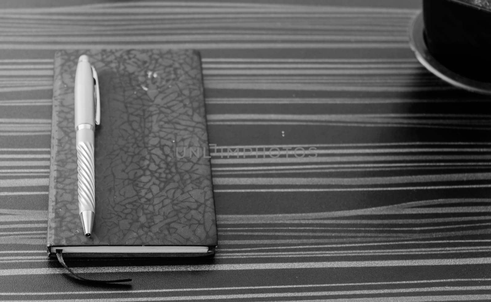 Pen and notebook on office table. Table top view. Corporate business background.
