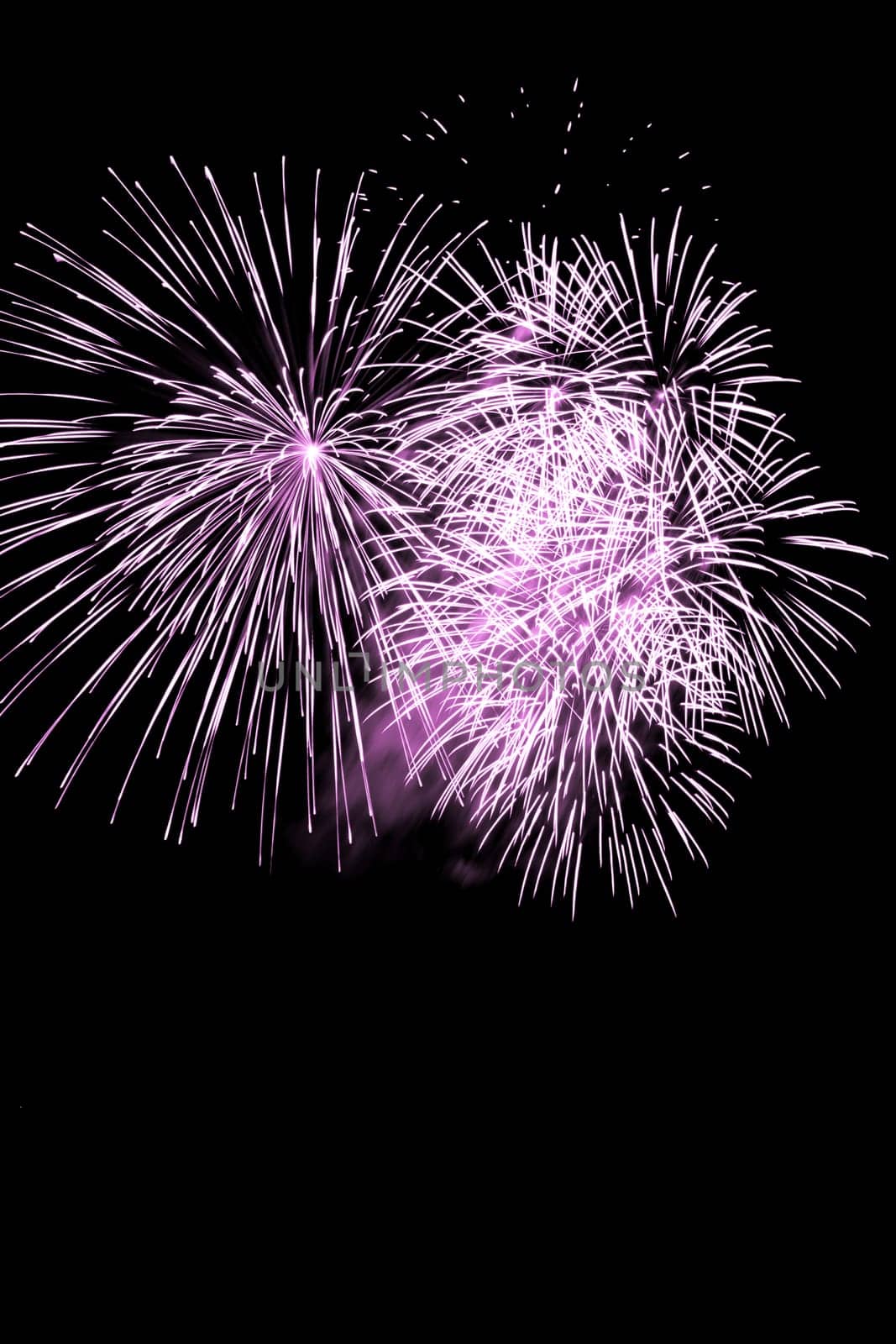 Premium entertainment magic star firework at e.g. New Years Eve or Independence Day party celebration. Black dark night background.
