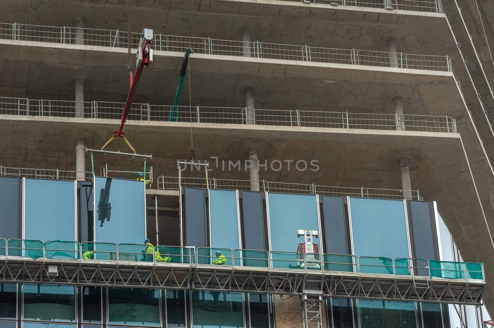 Workers inserting windows on a high-rise building, Frankfurt am Main, Germany
