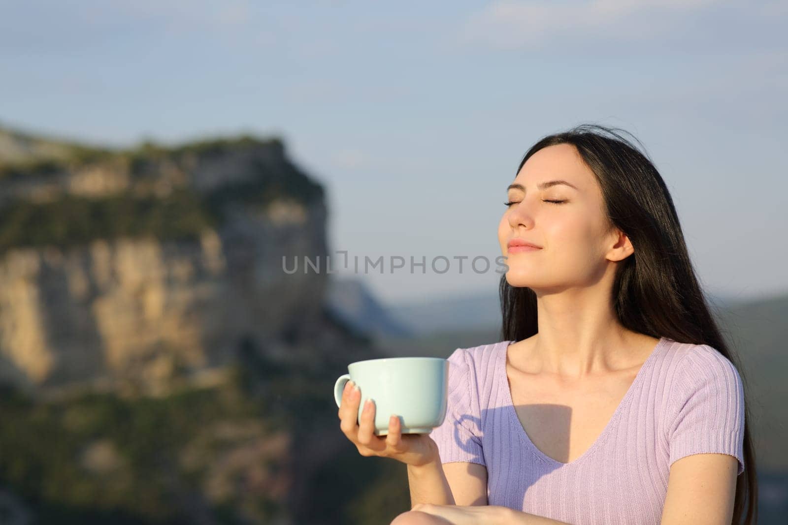 Asian woman drinking coffee relaxing enjoying nature