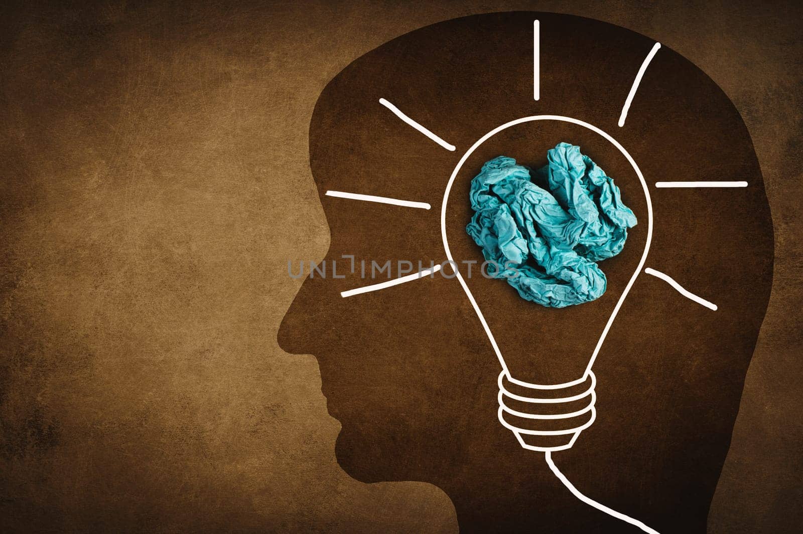 Silhouette of a face with a lightbulb, textured background, empty copy space for text