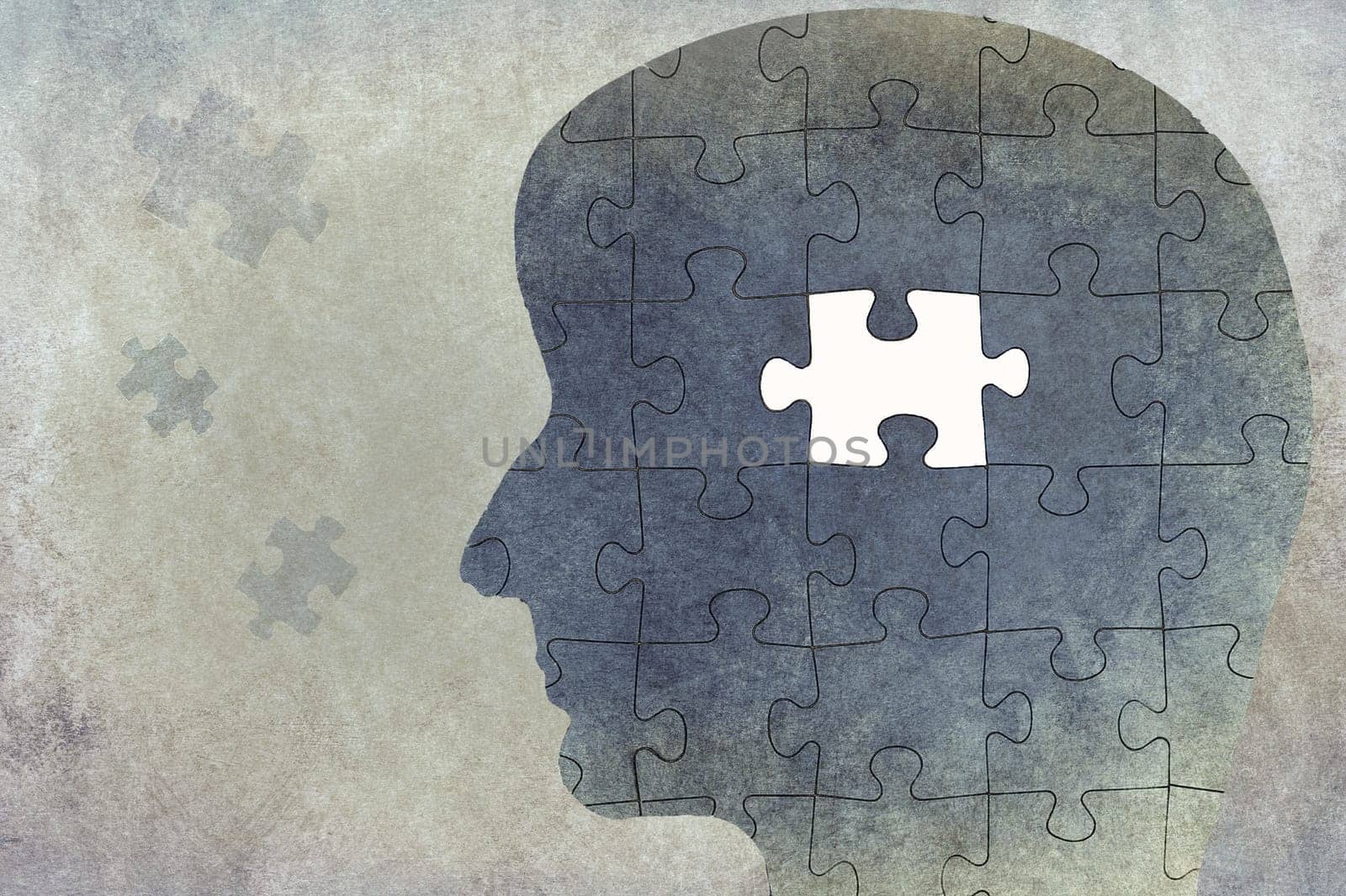 Silhouette of a head on a textured background, puzzle with missing part, thinking, mind, reminder