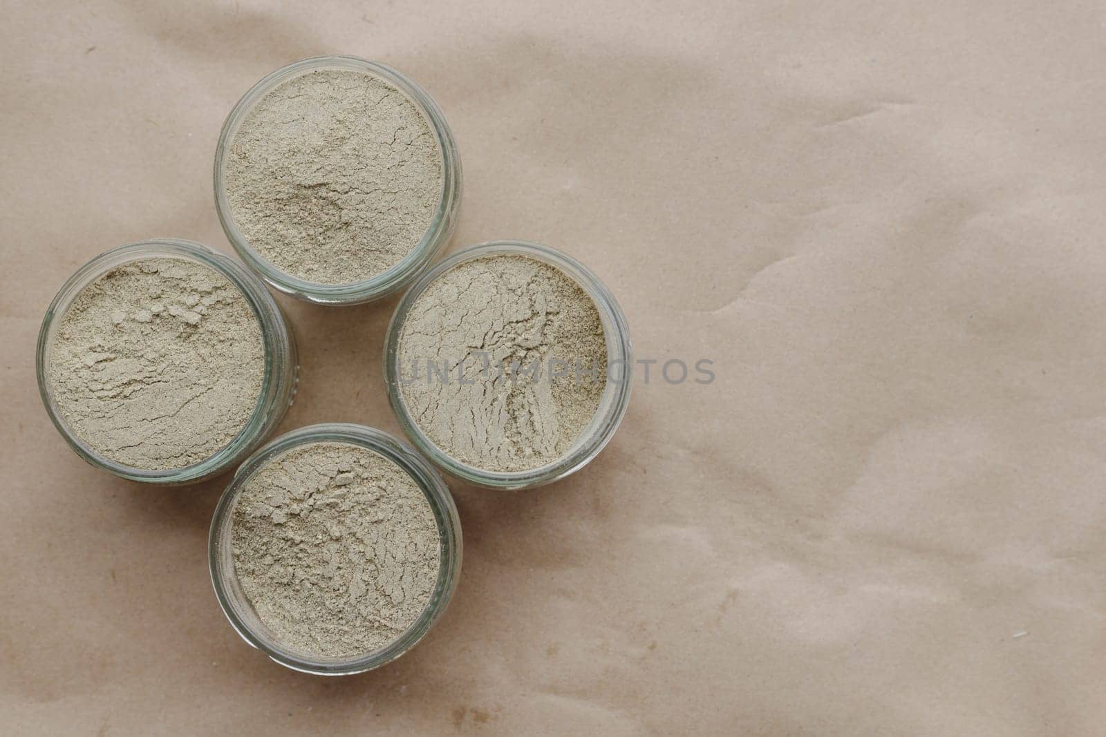 Ayurvedic cosmetic ubtan for face and hair care in glass jars. Vegetable ingredients ground into a powder.