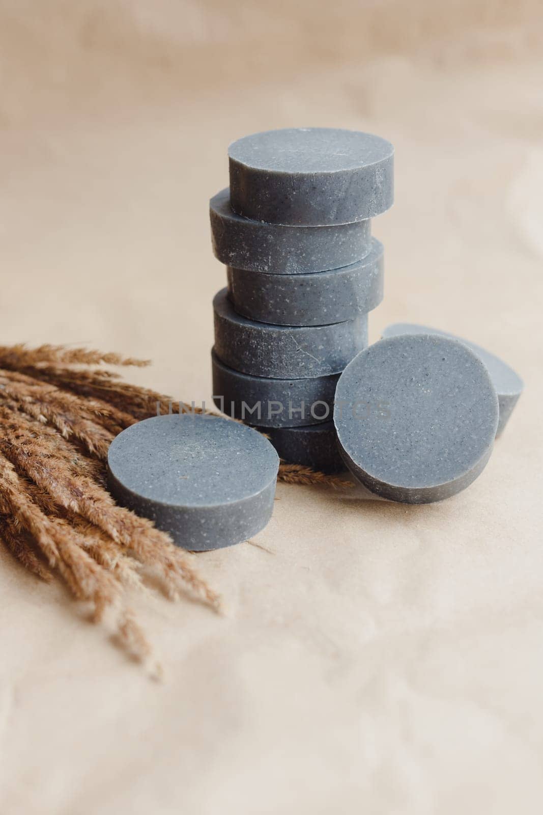 Stack of handmade solid shampoo and conditioner bars on paper background. Copy space for text