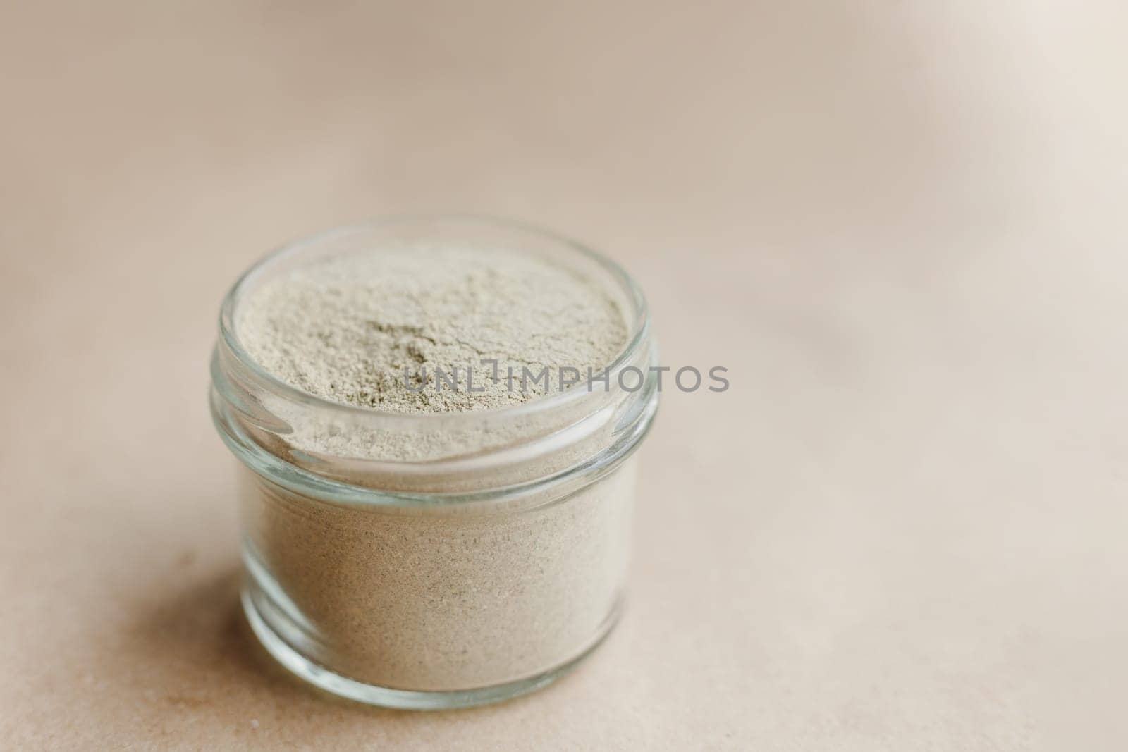 Ayurvedic cosmetic ubtan for face and hair care in glass jars. Vegetable ingredients ground into a powder.