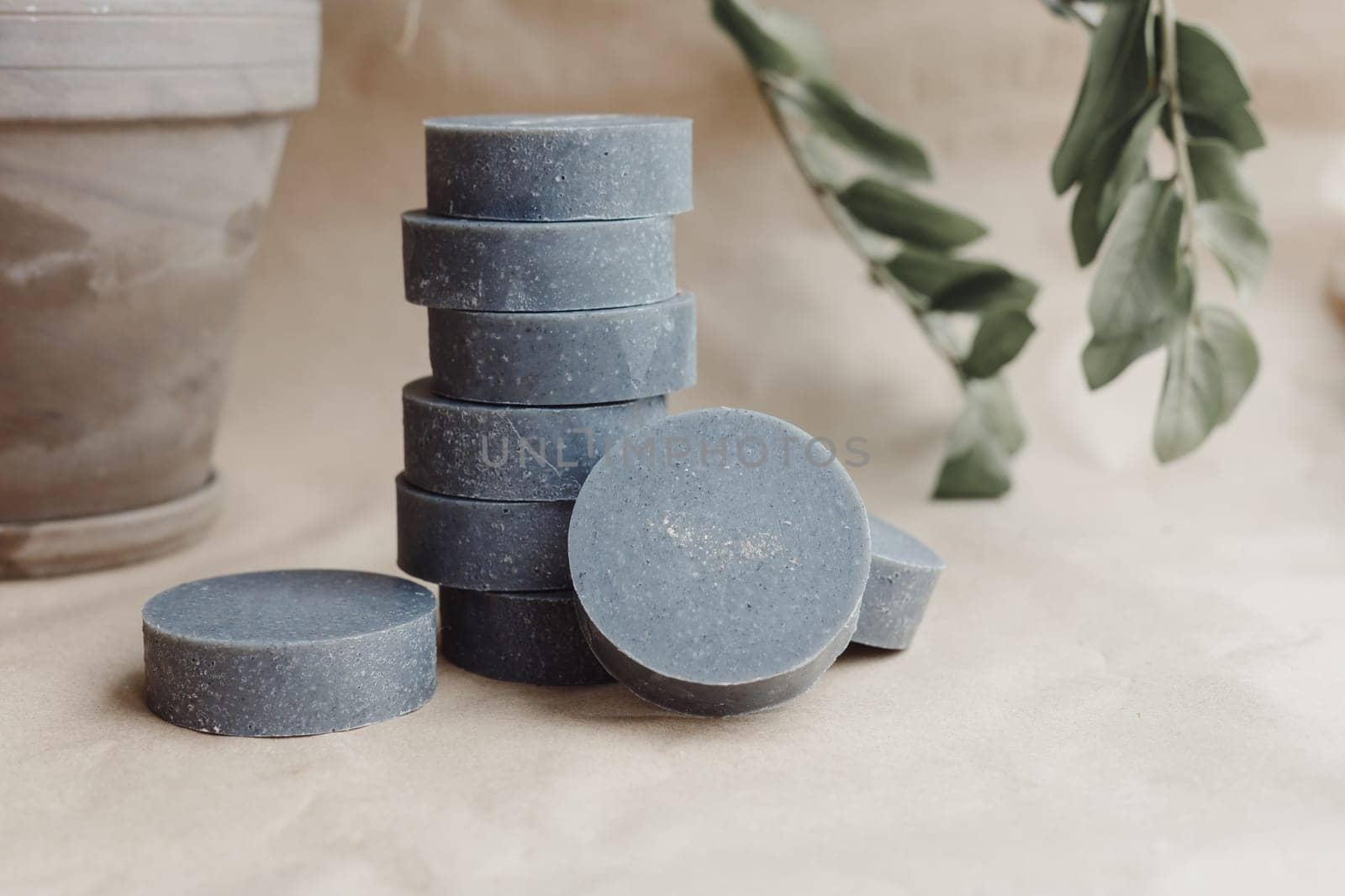 Stack of handmade solid shampoo and conditioner bars on paper background. Copy space for text