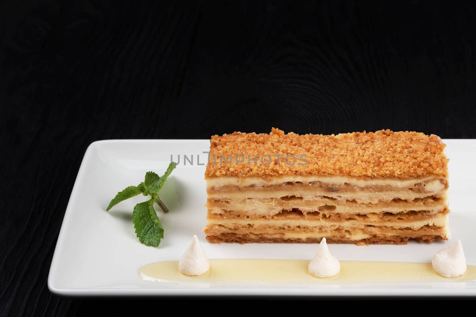 Esterhazy traditional cake with mint on black wooden background