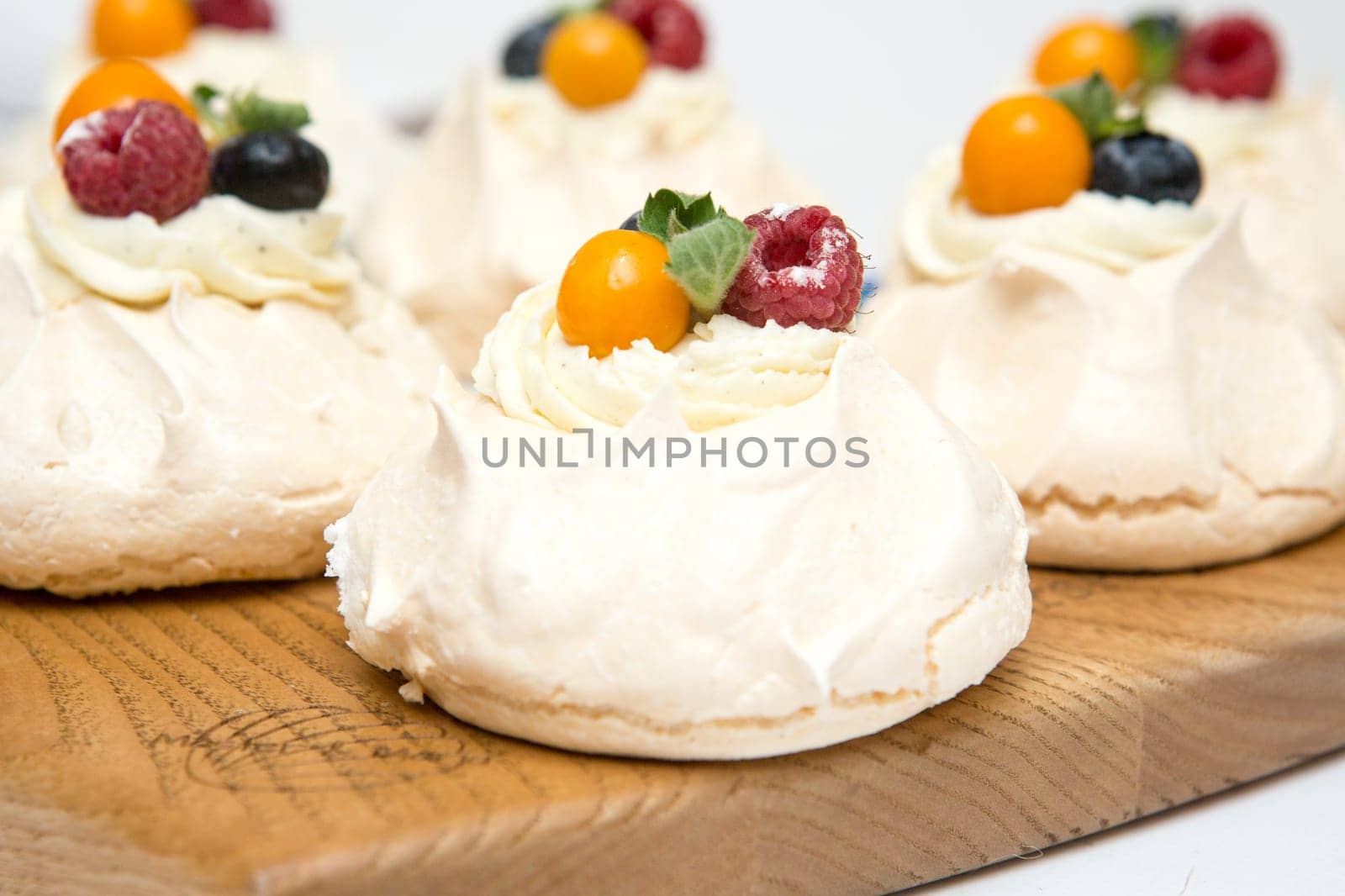 Pavlov's cake. Cakes on a platter. Sweet Dessert. A treat for the guests. Dessert for the holiday. The cake is decorated with berries