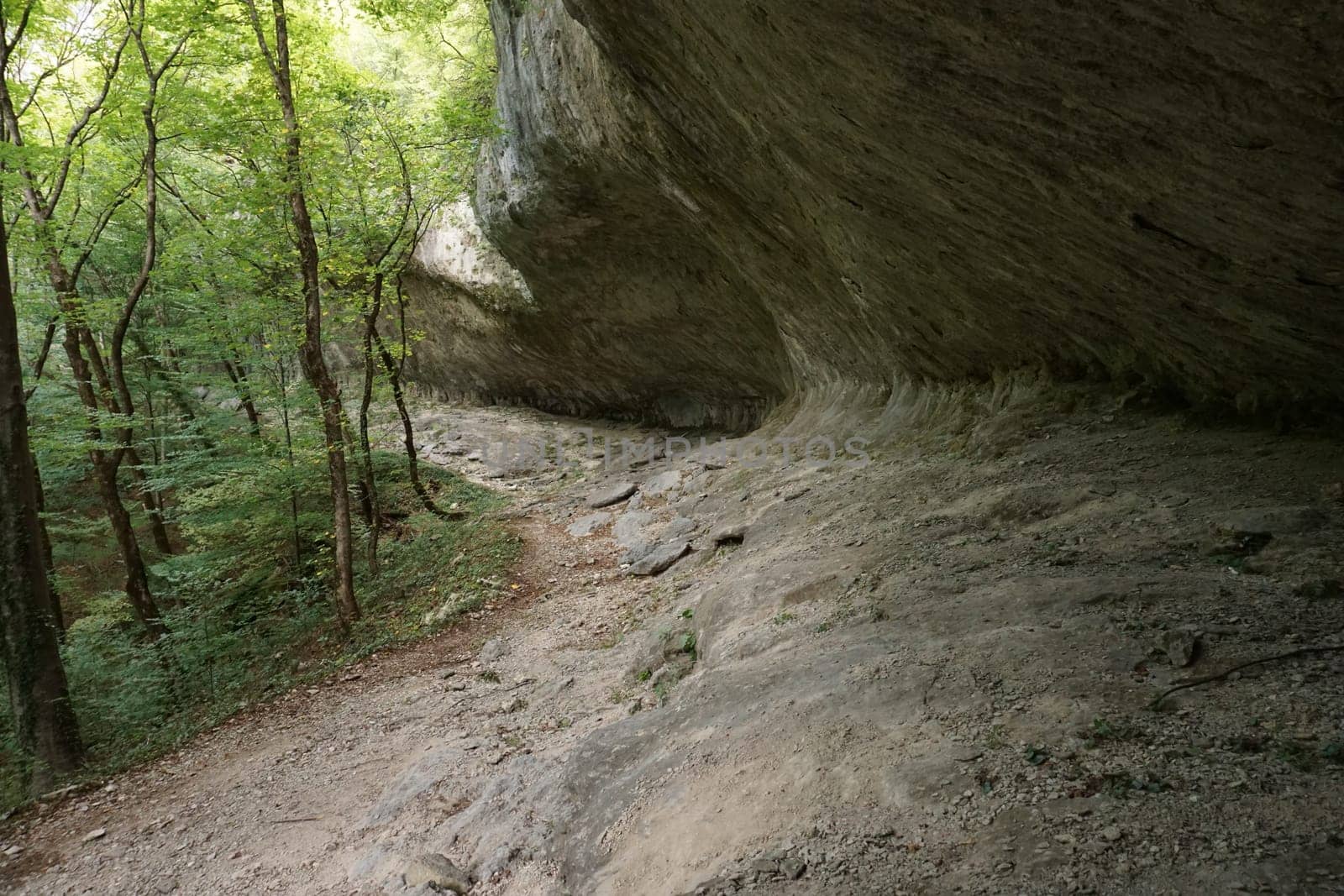 Walking under giant stone structure on the way to Bijela Canyon, 2020