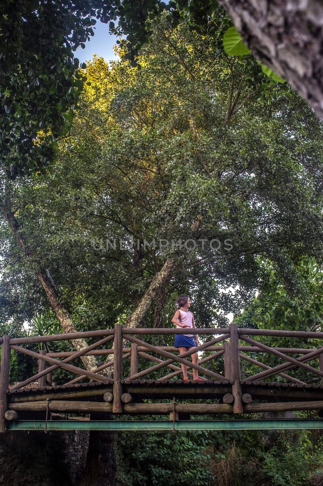 Child girl over The world shortest international bridge of El Marco. La Codosera district, Extremadura, Spain