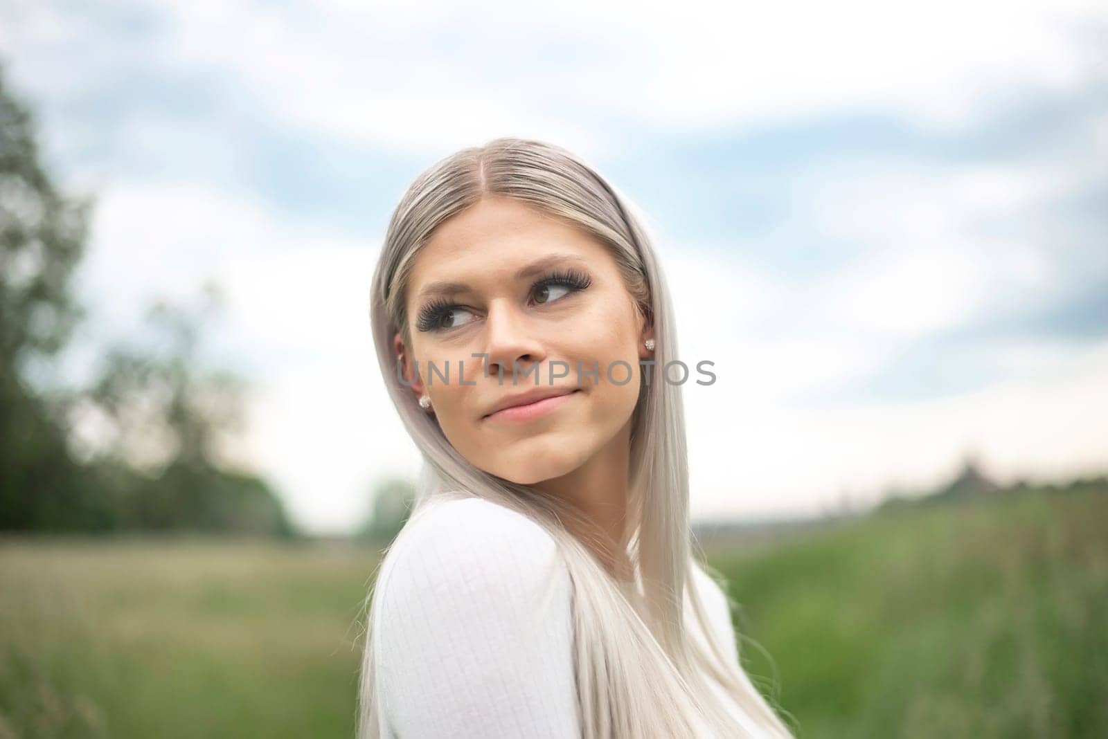 happy young blond girl on a meadow