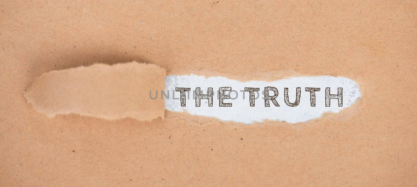 The words the truth standing on a ripped up paper