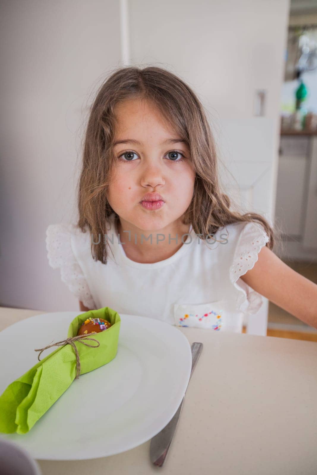 Portrait of adorable little girl with colorful Easter eggs at home, Holiday day
