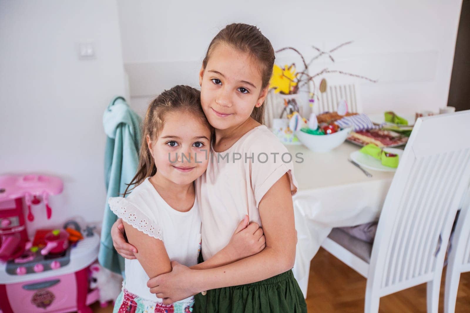 Portrait of two adorable little girls at home, Easter Holiday day