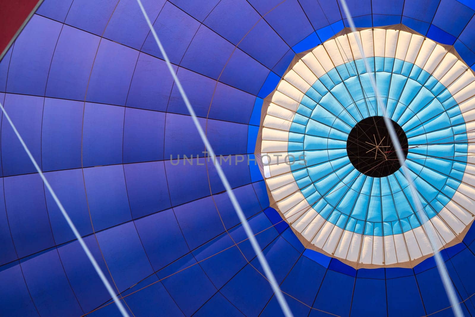 front view detail closeup of the colorful fabric interior texture of a hot air balloon during flight