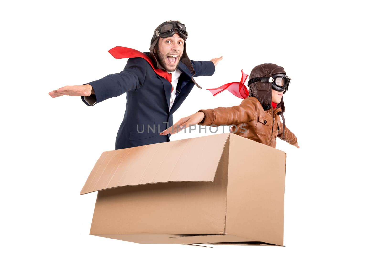 Man and kid playing. flying in a carboard box isolated in white