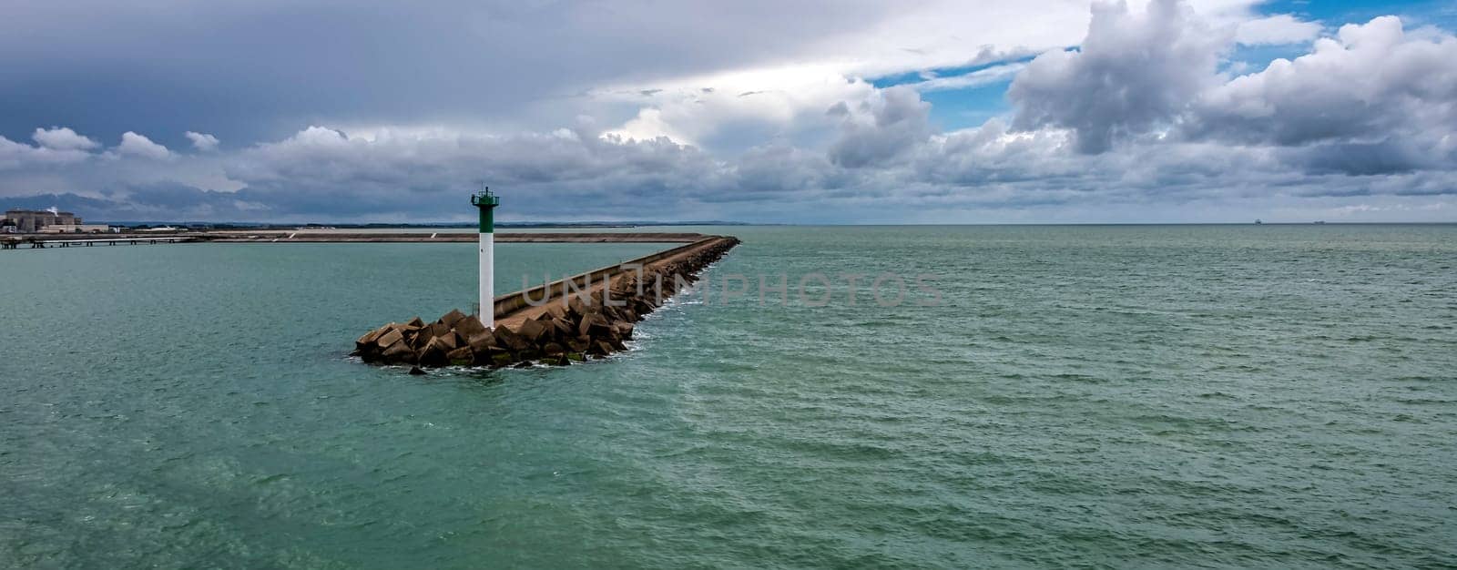 Breakwater with lighthouse on French coast - Calais, France