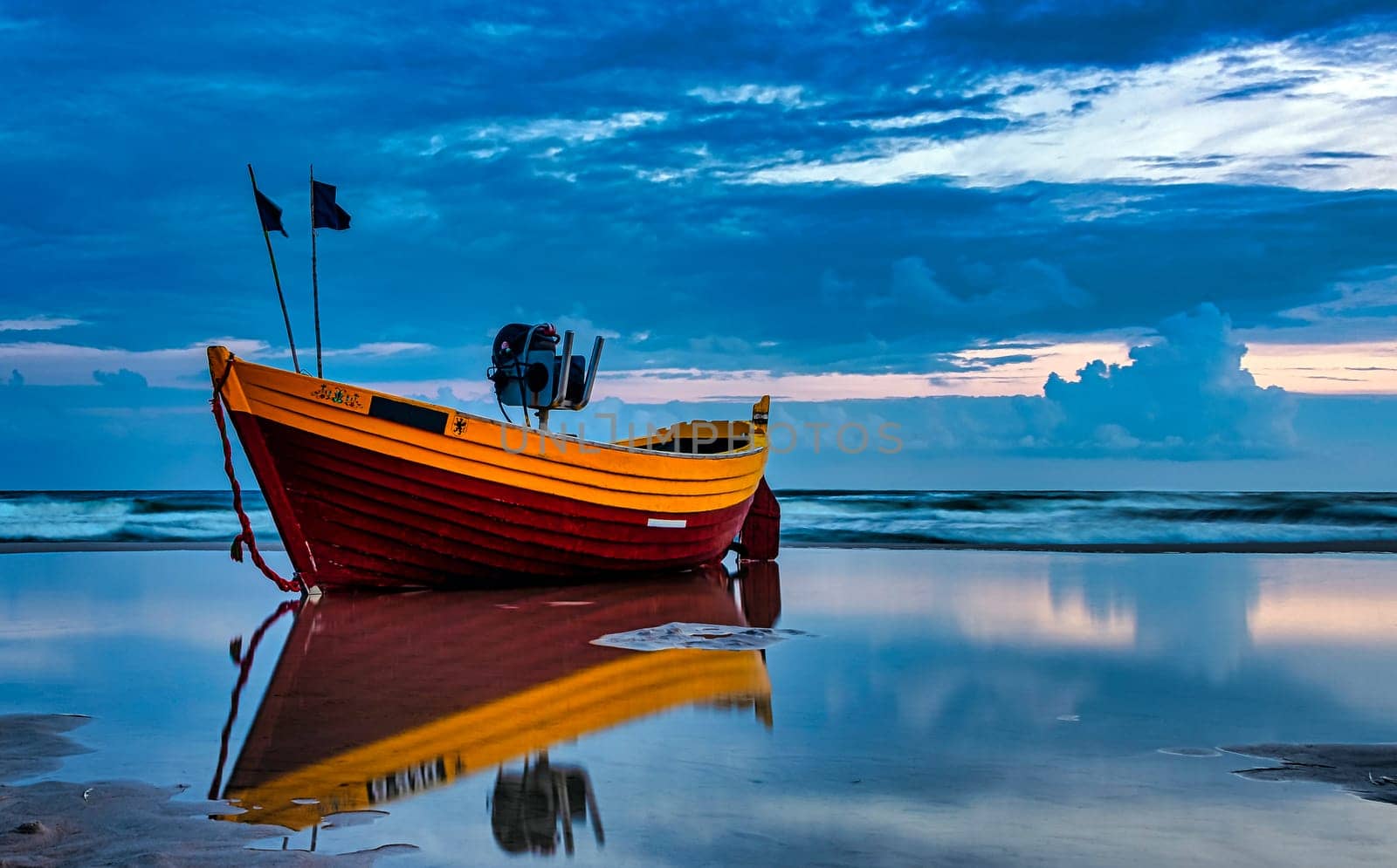 Sunset over Baltic Sea with fishing boat on the beach - Debki, Pomerania, Poland