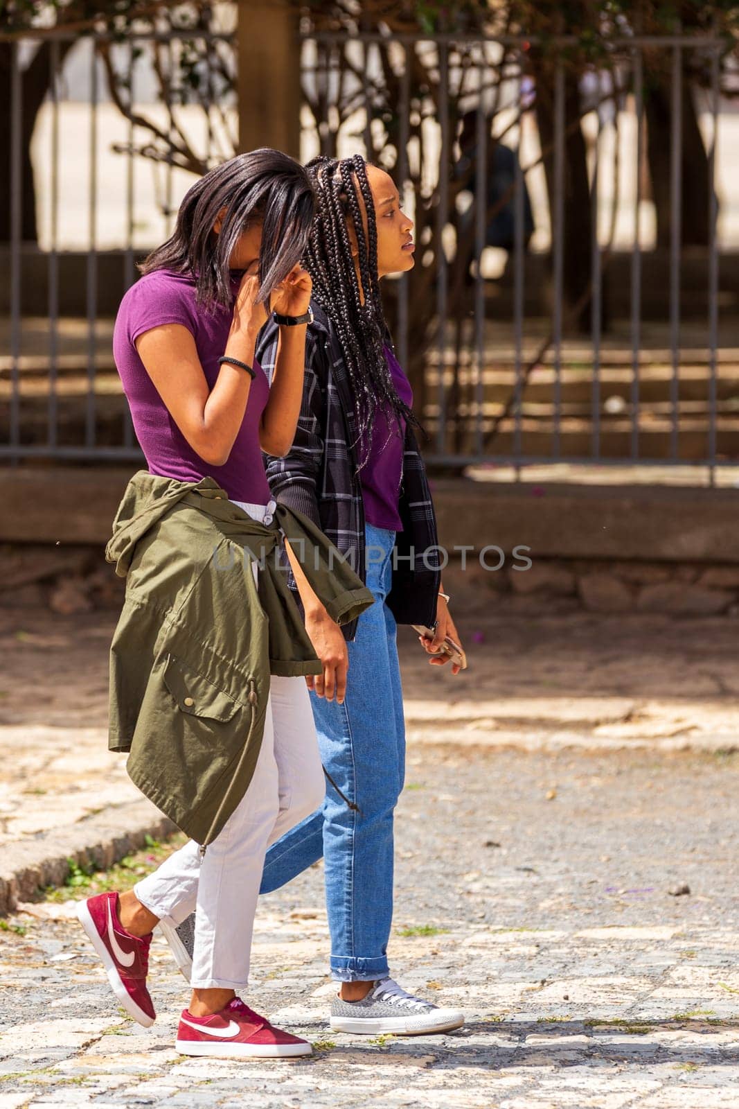 AXUM, ETHIOPIA, APRIL 27th.2019: Ordinary carefree tigray native girls walking on the street in center of Aksum on April 27, 2019 in Aksum, Tigray, Ethiopia Africa