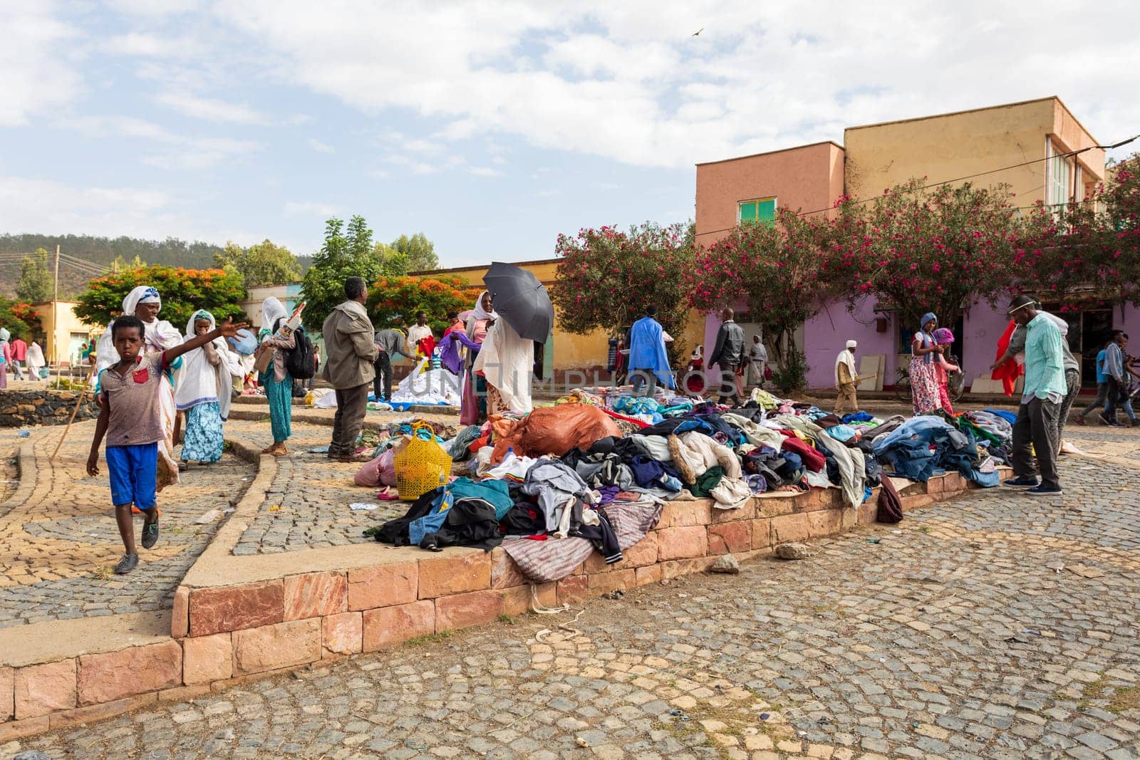AXUM, ETHIOPIA, APRIL 27th.2019: Tigray native people in street market with clothes in center of Aksum on April 27, 2019 in Aksum, Tigray, Ethiopia Africa