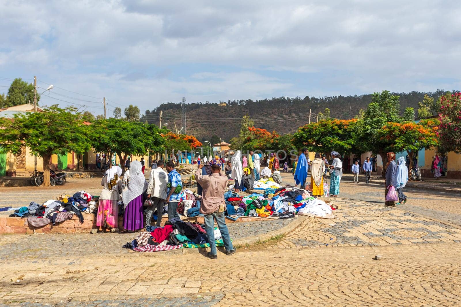 AXUM, ETHIOPIA, APRIL 27th.2019: Tigray native people in street market with clothes in center of Aksum on April 27, 2019 in Aksum, Tigray, Ethiopia Africa