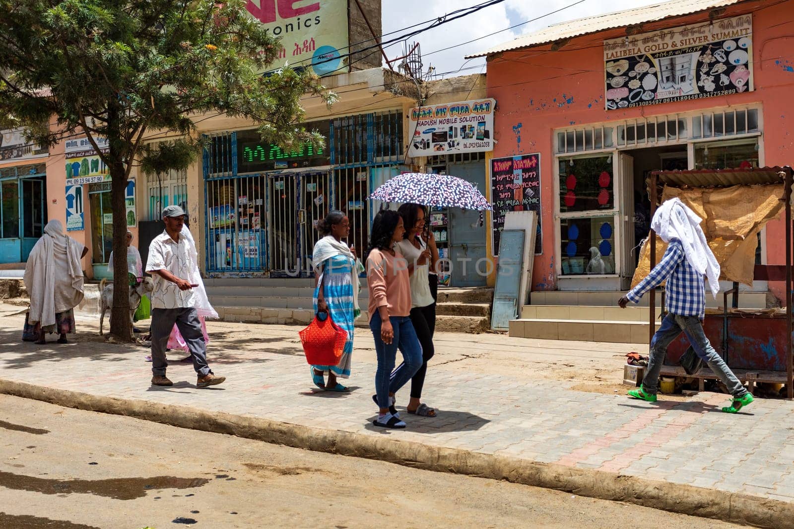 AXUM, ETHIOPIA, APRIL 27th.2019: Ordinary carefree tigray native woman walking on the street in center of Aksum on April 27, 2019 in Aksum, Tigray, Ethiopia Africa