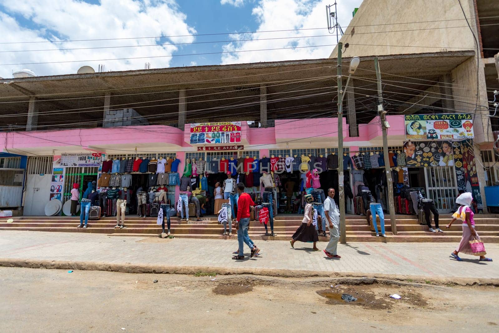 AXUM, ETHIOPIA, APRIL 27th.2019: Tigray native people in market with clothes in center of Aksum on April 27, 2019 in Aksum, Tigray, Ethiopia Africa