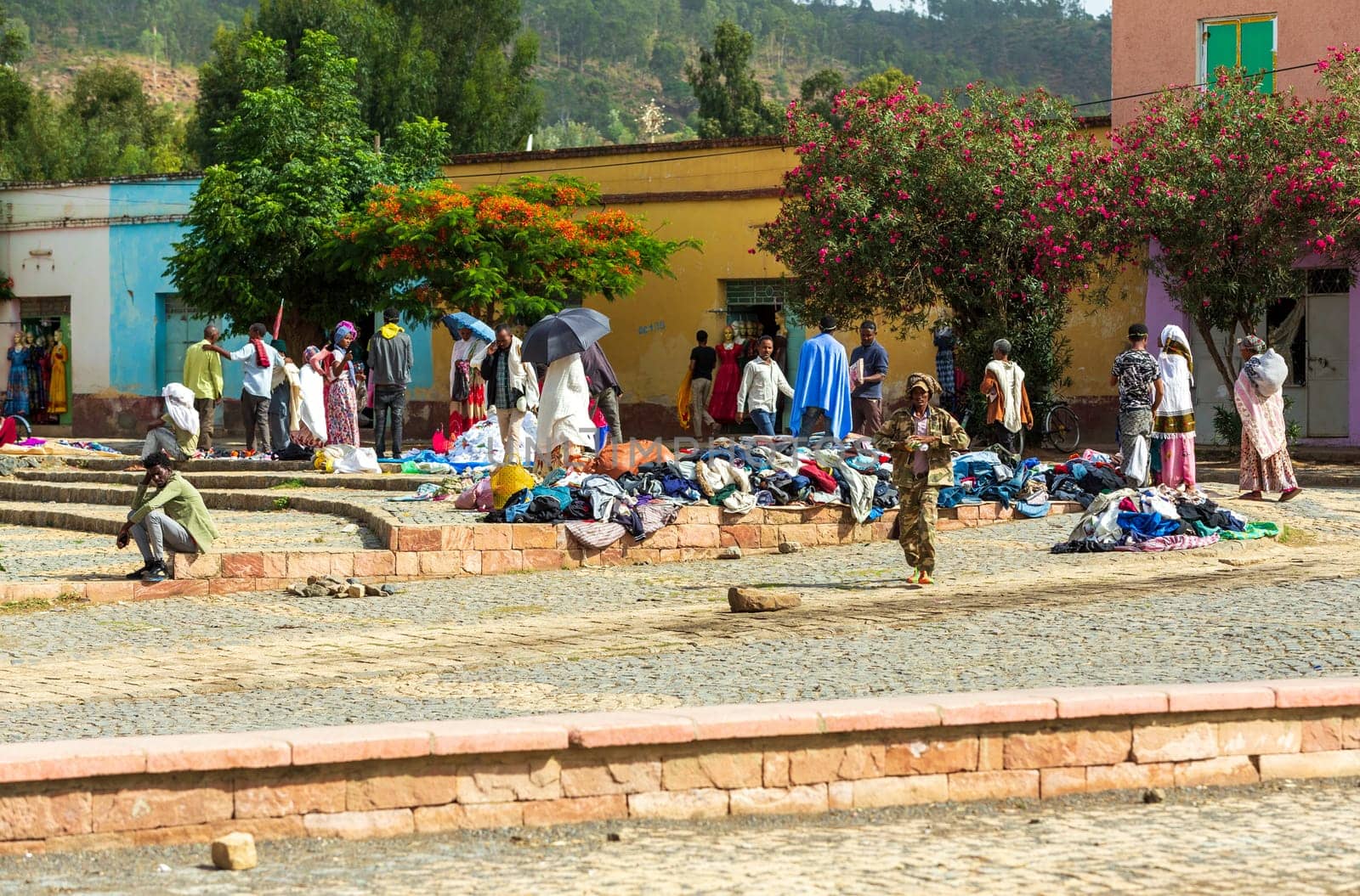 AXUM, ETHIOPIA, APRIL 27th.2019: Tigray native people in street market with clothes in center of Aksum on April 27, 2019 in Aksum, Tigray, Ethiopia Africa