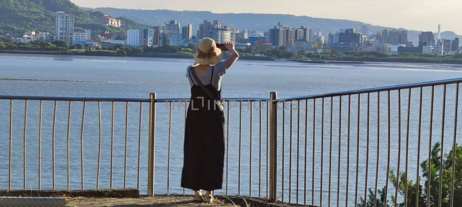 Tamsui, NEW TAIPEI CITY, TAIWAN - Sep 8, 2021 - City Tamsui Bali District in Taipei, Taiwan reflecting in the Tamsui River at nice day