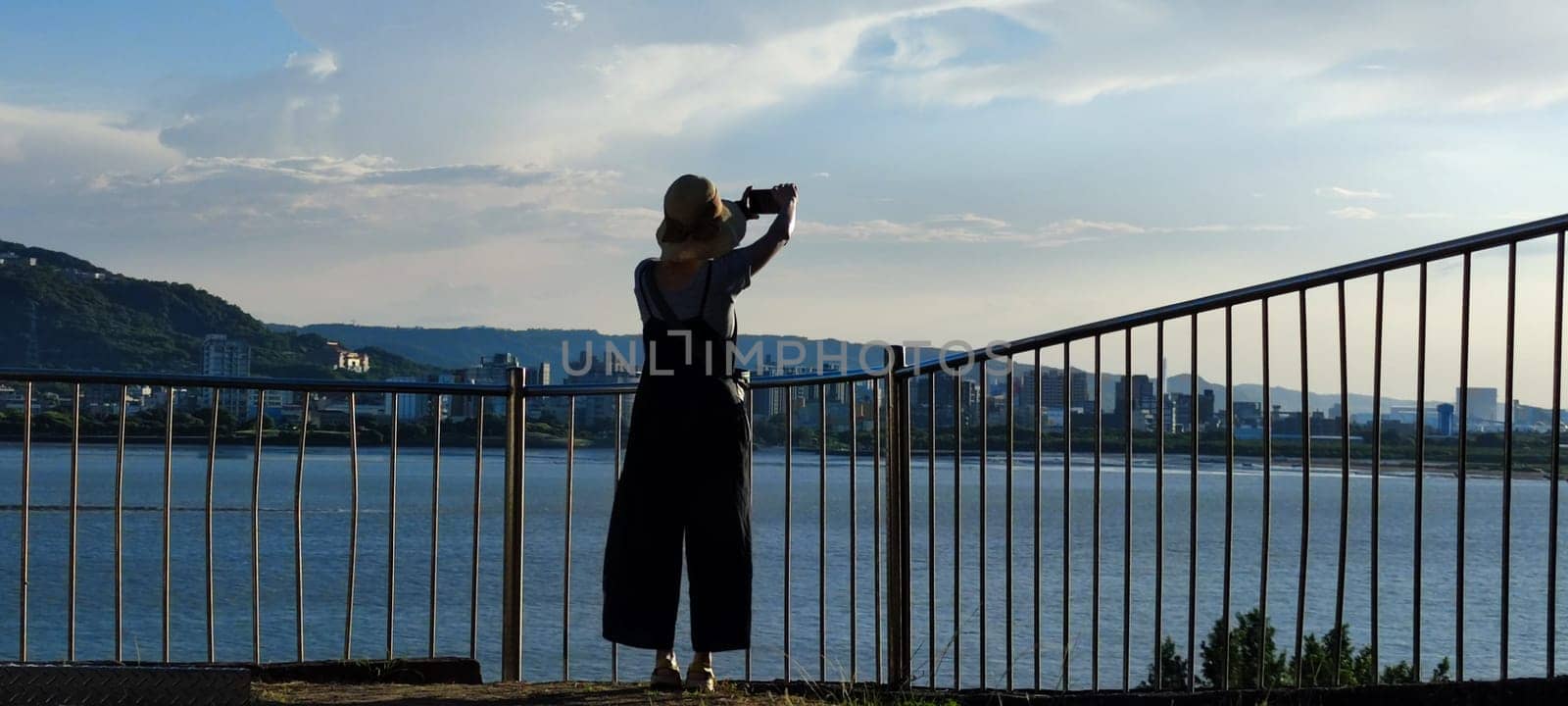 Tamsui, NEW TAIPEI CITY, TAIWAN - Sep 8, 2021 - City Tamsui Bali District in Taipei, Taiwan reflecting in the Tamsui River at nice day