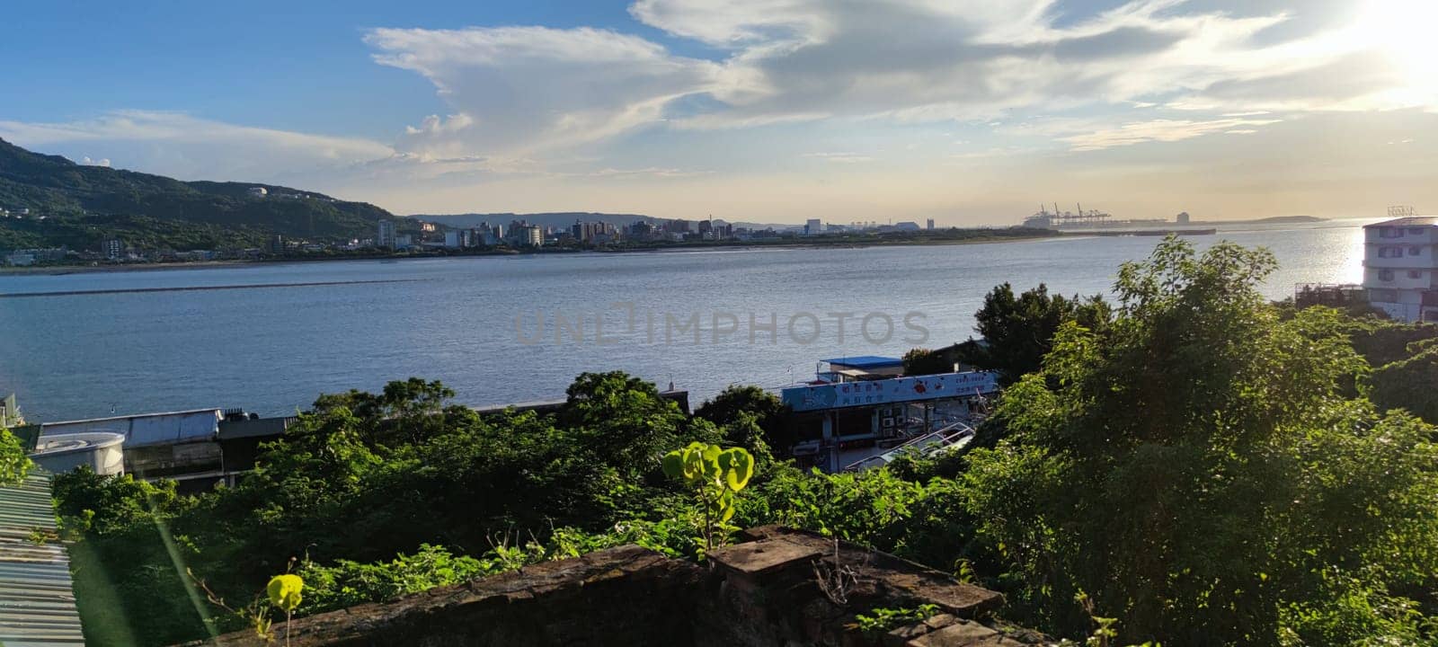 Tamsui, NEW TAIPEI CITY, TAIWAN - Sep 8, 2021 - City Tamsui Bali District in Taipei, Taiwan reflecting in the Tamsui River at nice day