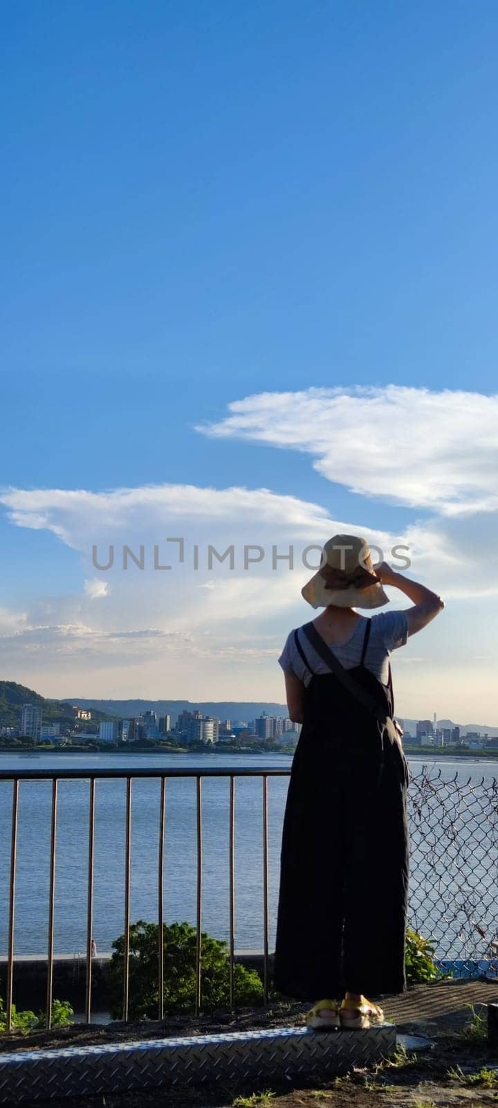 Tamsui, NEW TAIPEI CITY, TAIWAN - Sep 8, 2021 - City Tamsui Bali District in Taipei, Taiwan reflecting in the Tamsui River at nice day