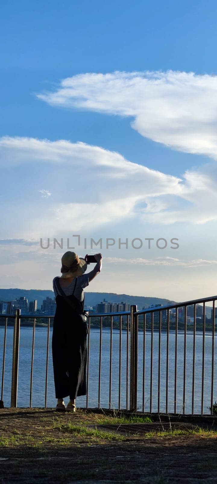 Tamsui, NEW TAIPEI CITY, TAIWAN - Sep 8, 2021 - City Tamsui Bali District in Taipei, Taiwan reflecting in the Tamsui River at nice day