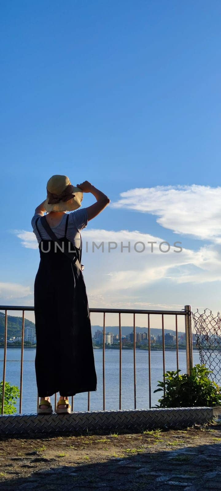 Tamsui, NEW TAIPEI CITY, TAIWAN - Sep 8, 2021 - City Tamsui Bali District in Taipei, Taiwan reflecting in the Tamsui River at nice day