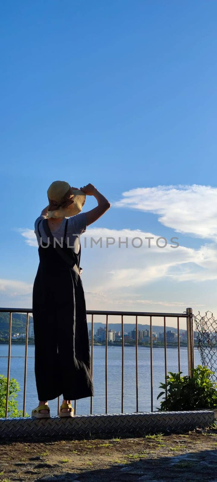 Tamsui, NEW TAIPEI CITY, TAIWAN - Sep 8, 2021 - City Tamsui Bali District in Taipei, Taiwan reflecting in the Tamsui River at nice day