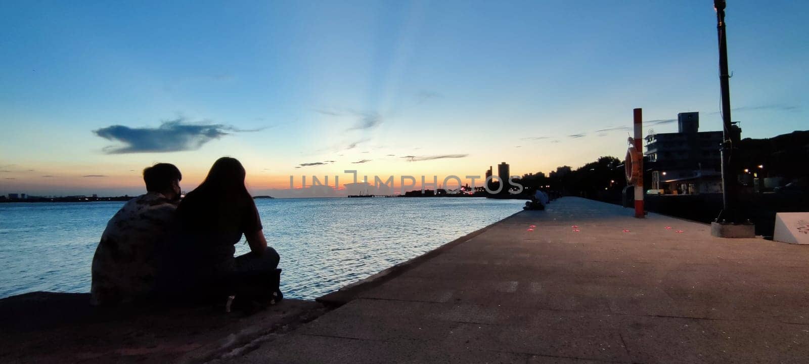 Tamsui, NEW TAIPEI CITY, TAIWAN - Sep 8, 2021 - City Tamsui Bali District in Taipei, Taiwan reflecting in the Tamsui River at nice day