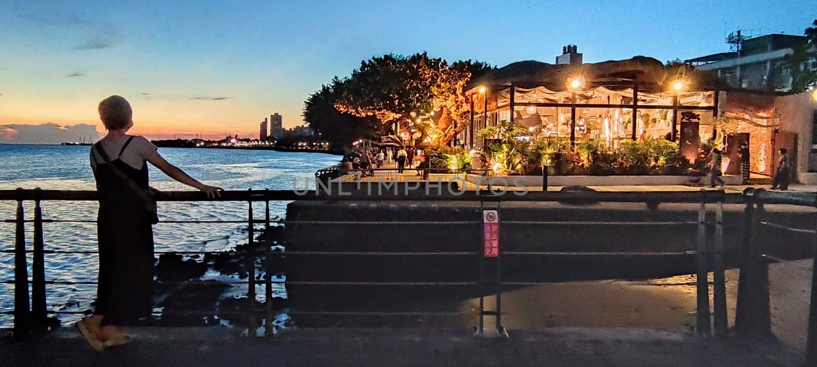 Tamsui, NEW TAIPEI CITY, TAIWAN - Sep 8, 2021 - City Tamsui Bali District in Taipei, Taiwan reflecting in the Tamsui River at nice day