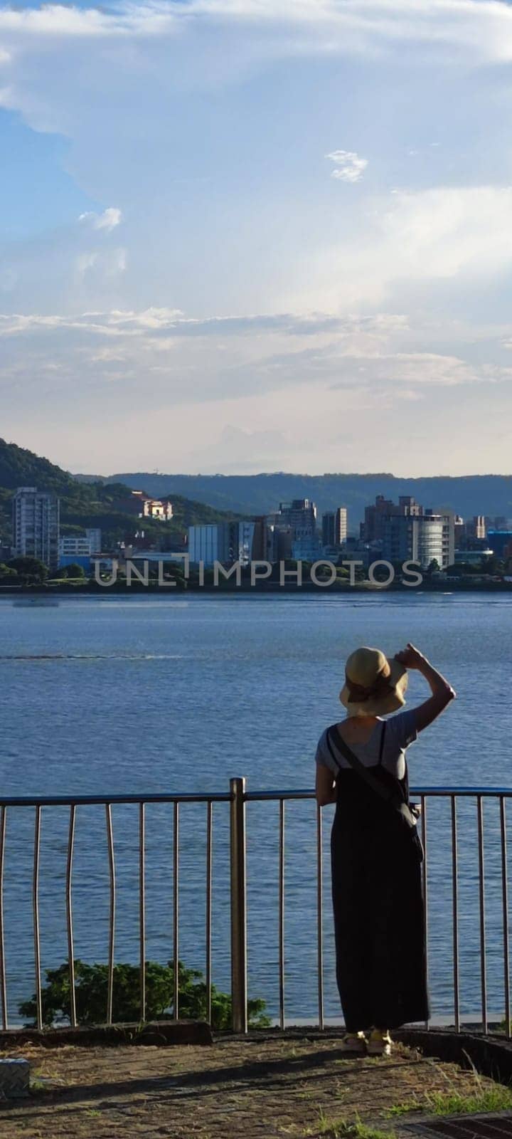 Tamsui, NEW TAIPEI CITY, TAIWAN - Sep 8, 2021 - City Tamsui Bali District in Taipei, Taiwan reflecting in the Tamsui River at nice day