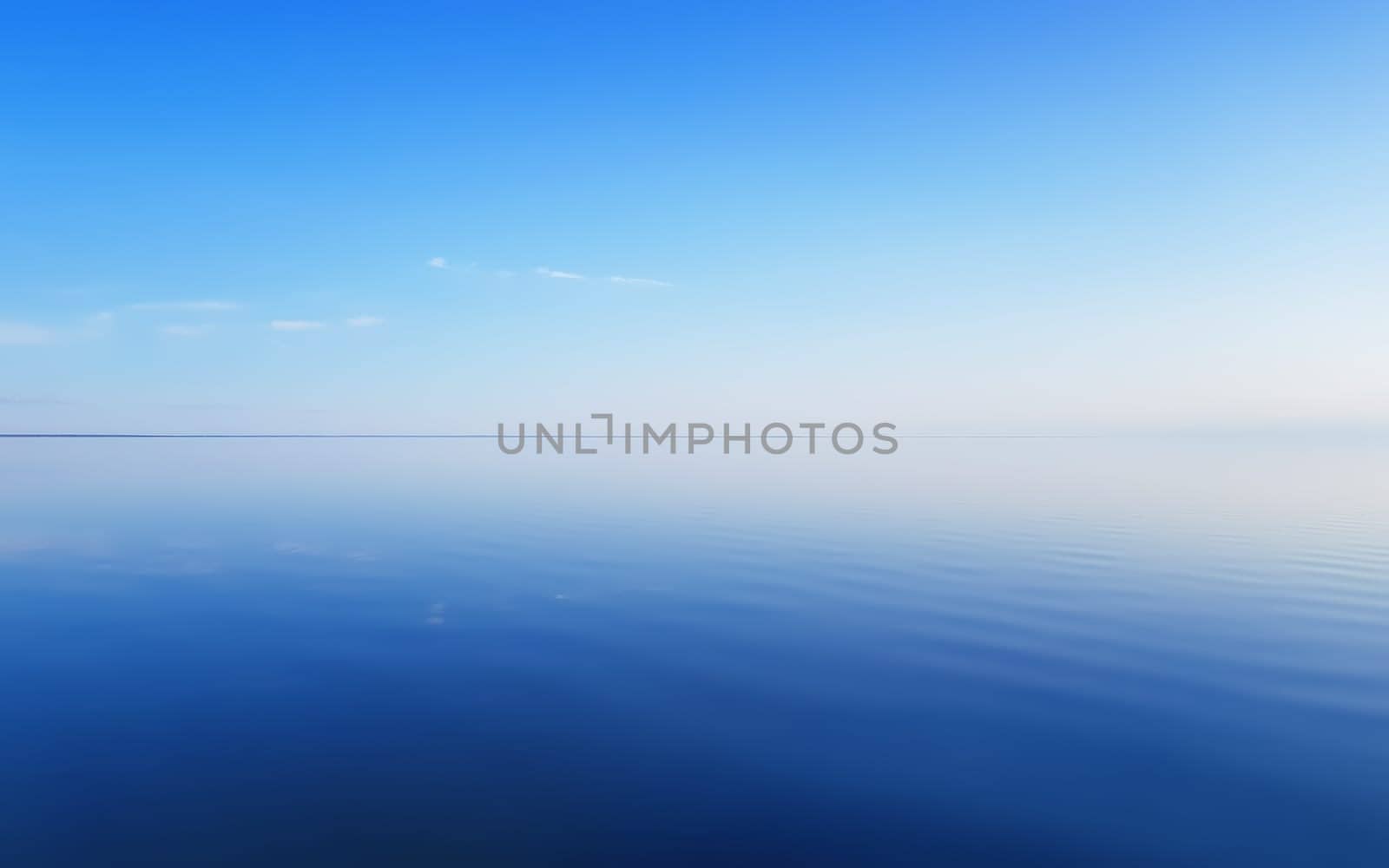 The clear blue sky is reflected in the smooth water surface. Serene summer seascape background with space for copy.