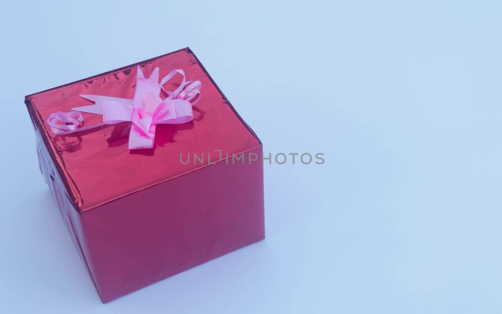 Red Gift box with Ribbon in white background. Copy Space
