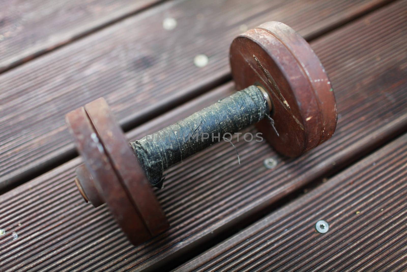 heavy steel dumbbell, handle rewound with black duct tape