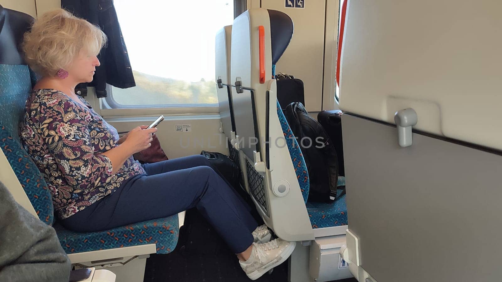 October 16 2024 Prague Czech Republic Europe Woman train phone windows travel tourism transport . High quality photo