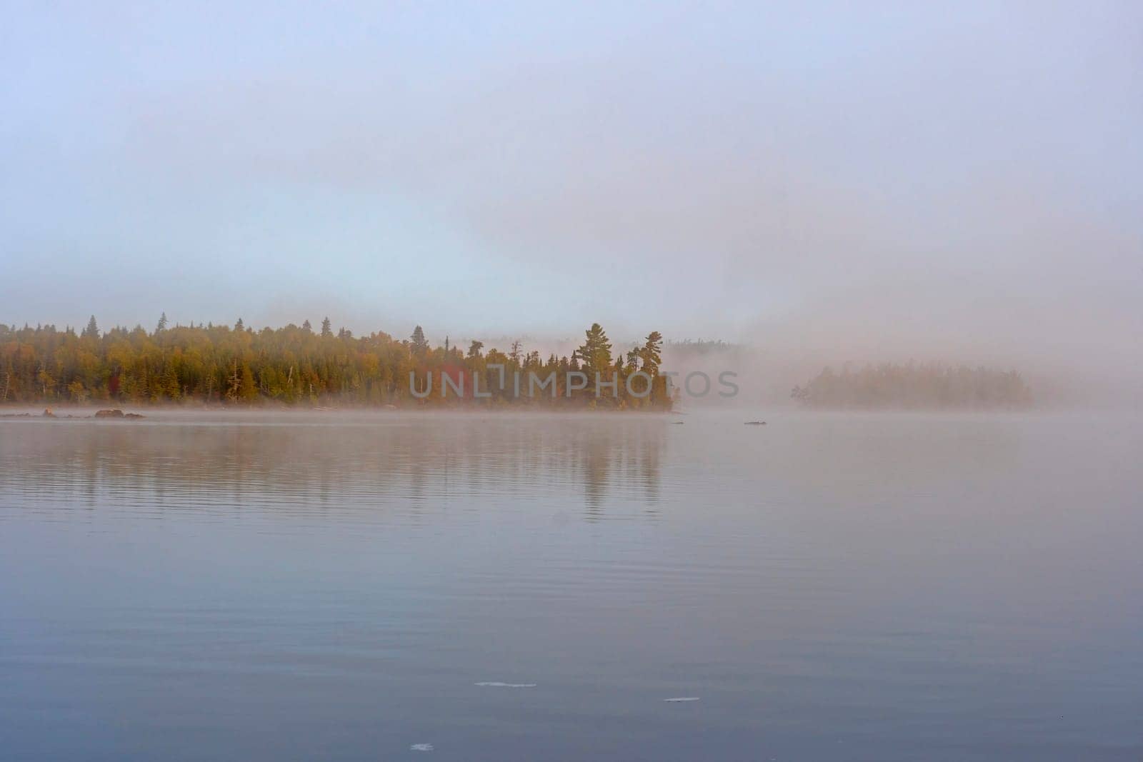 Morning Mist Slowly Clearing in the North Woods on Saganaga Lake in the Boundary Waters in Minnesota