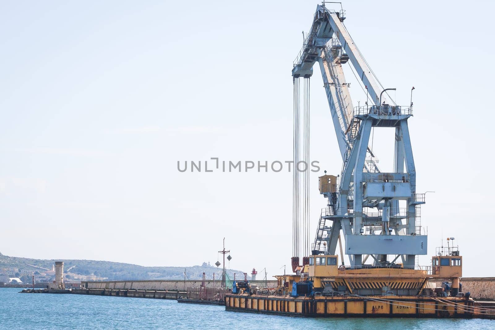Old crane at the dock of the port