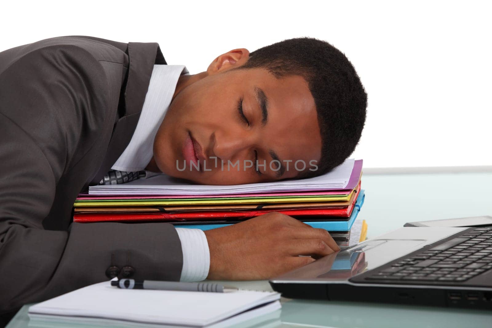Worker sleeping on a stack of folders