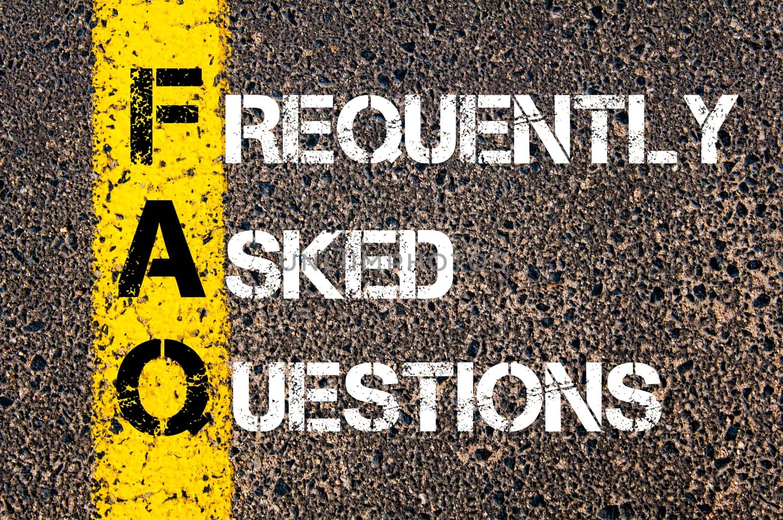 Acronym FAQ - Frequently Asked Questions. Business Conceptual image with yellow paint line on the road over asphalt stone background.