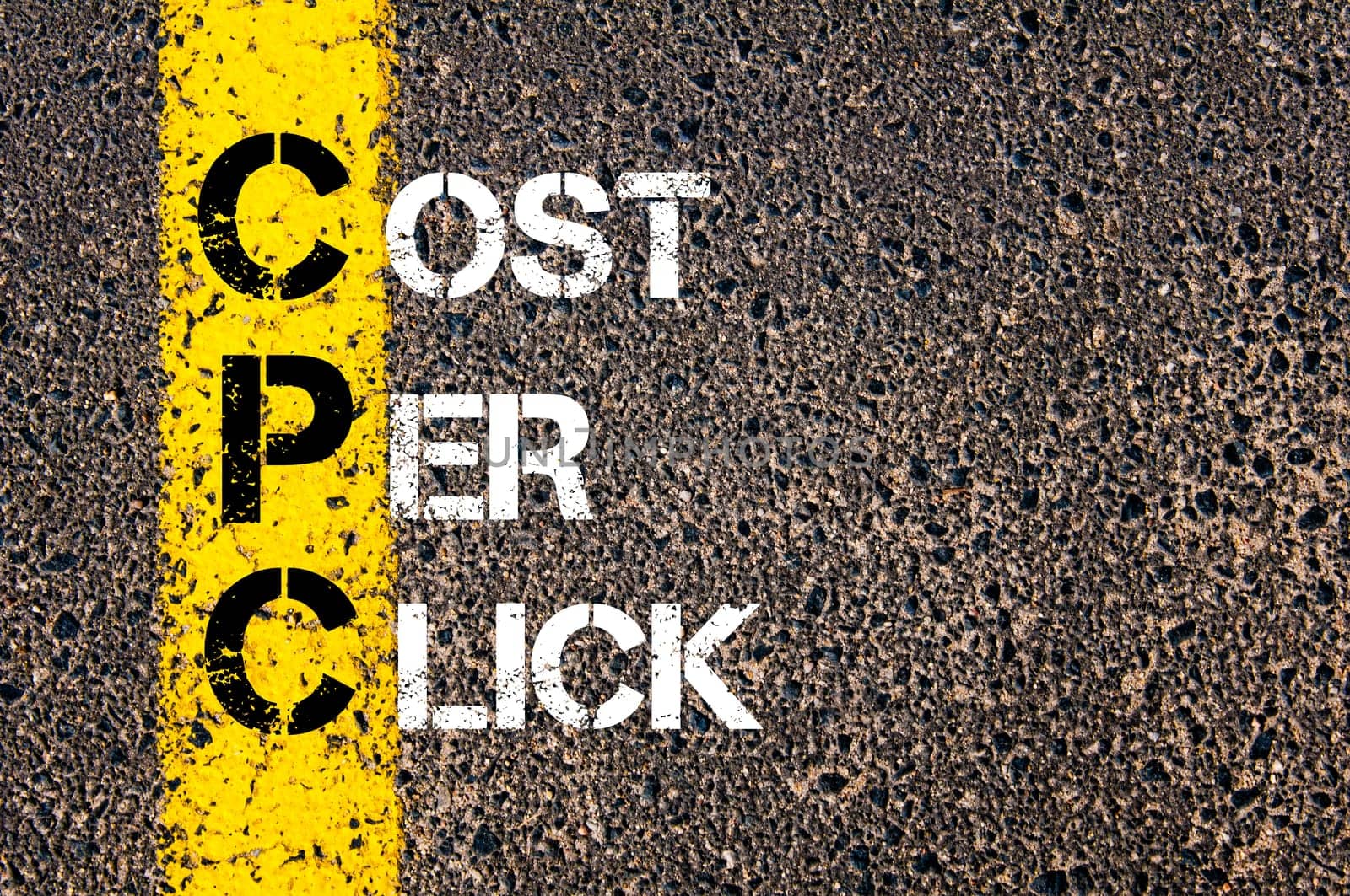 Acronym CPC- Cost Per Click. Business Conceptual image with yellow paint line on the road over asphalt stone background.