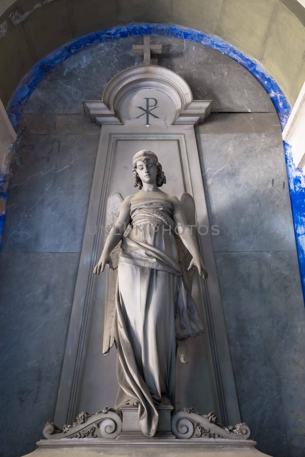 GENOA, ITALY - June 2020: antique statue of angel (beginning 1900, marble) in a Christian Catholic cemetery - Italy