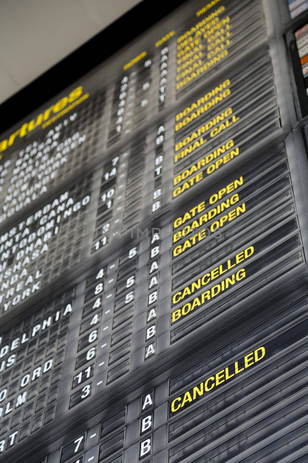 Airport departure board in terminal with flight information