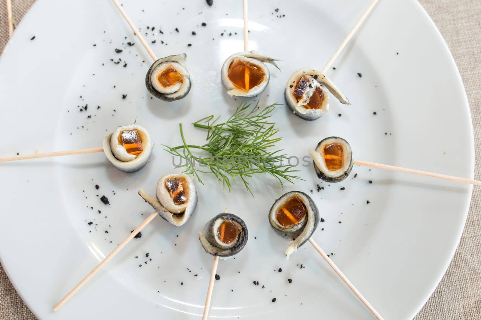 Vinegar pickled anchovies brochettes rolled with jelly. Selective focus